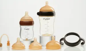 Two baby bottles and accessories. Consider how often to replace plastic baby bottles for safety.