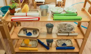 Montessori ideas: Shelves with practical life activities like pouring, washing, and transferring. Includes buckets, bowls, cups, and sponges.