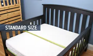 A standard size crib mattress fits perfectly in this toddler bed, showing it does a crib mattress fit a toddler bed.