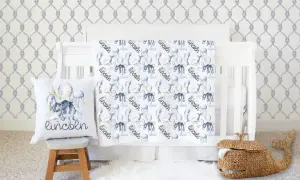 Nautical nursery with under the sea crib bedding sets featuring octopuses, narwhals, and jellyfish. A whale basket sits nearby.