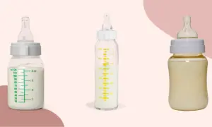 Two glass baby bottles filled with milk sit beside a plastic one, showcasing the difference between glass baby bottles vs plastic.