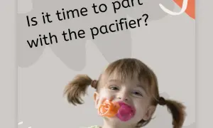 A happy toddler with pigtails is chewing on three pacifiers at once. Is it time to part with the pacifier?