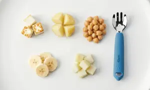 A child can eat with a fork when they master finger foods like these: paneer cubes, potato wedges, chickpeas, banana slices, and melon cubes.