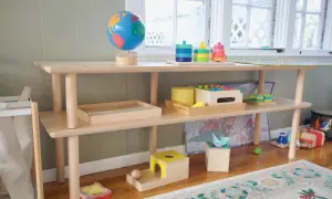 A Montessori shelf for a 1-year-old features a globe, stacking toys, and wooden puzzles, encouraging exploration and learning.