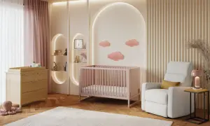 A serene nursery with pink crib, changing table, and cloud decor. This sweet setup is perfect for baby girl nursery themes.