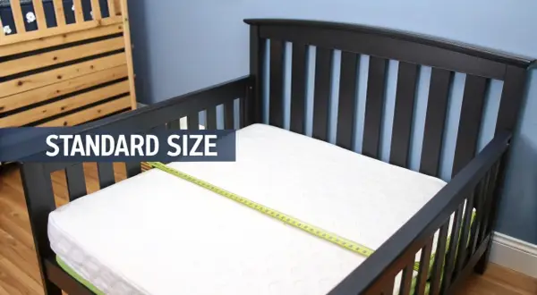 A standard size crib mattress fits perfectly in this toddler bed, showing it does a crib mattress fit a toddler bed.