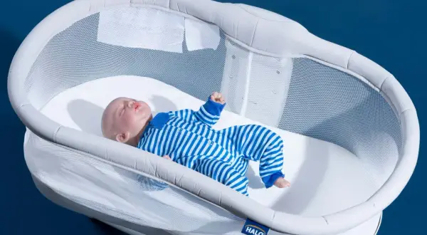 A baby doll sleeps soundly in a Halo bassinet, a safe and stylish alternative to traditional cribs.