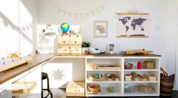 Inspiring Montessori shelf ideas for a child's learning space, featuring a globe, animal figures, and organized trays of educational materials.