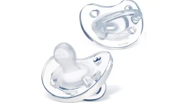 Two silicone pacifiers: one orthodontic, the other round.