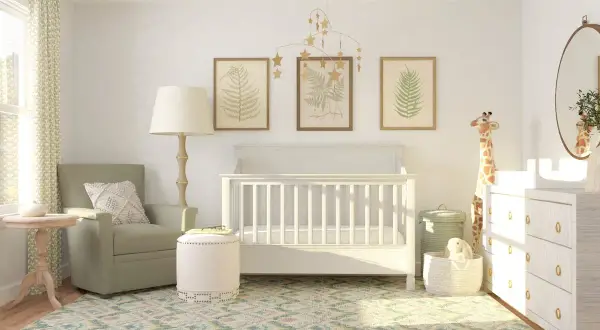 Serene nursery with a white crib, botanical art, and a giraffe plush. Great crib decoration ideas for a calm, nature-inspired room.