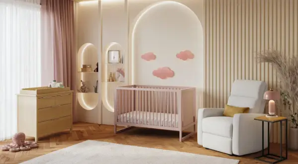 A serene nursery with pink crib, changing table, and cloud decor. This sweet setup is perfect for baby girl nursery themes.