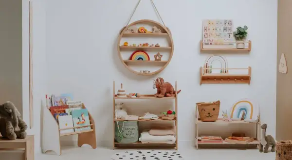 A serene nursery showcasing Montessori organization at home. Wooden shelves display books, toys, and soft blankets, creating a calm and inviting space for a child.