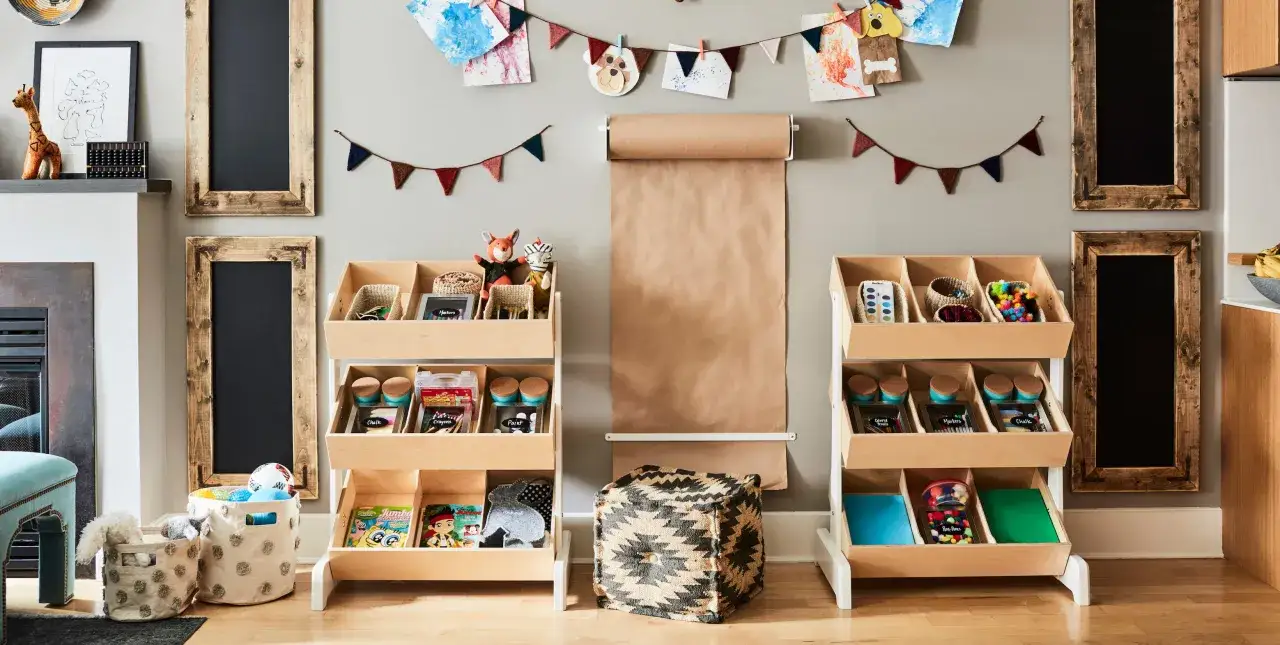 This is a perfect toy room inspiration! Shelving units organize art supplies and toys, while a large paper roll encourages creativity.