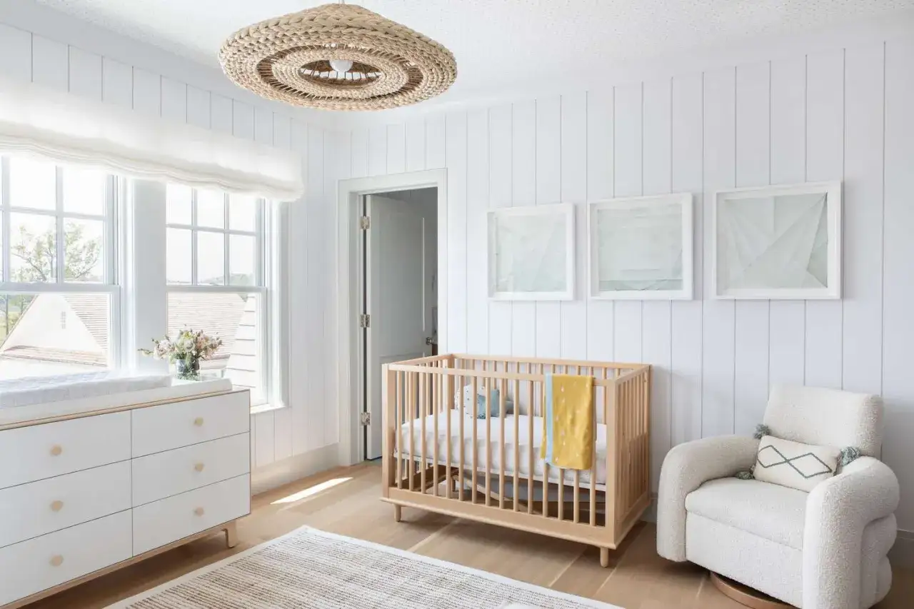 Natural wood crib with yellow blanket, offering lovely crib color ideas for a bright nursery.