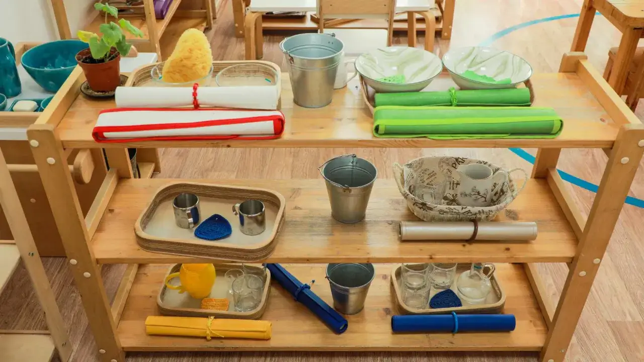 Montessori ideas for practical life: trays with pouring pitchers, cups, buckets, and sponges, promoting independence and fine motor skills.