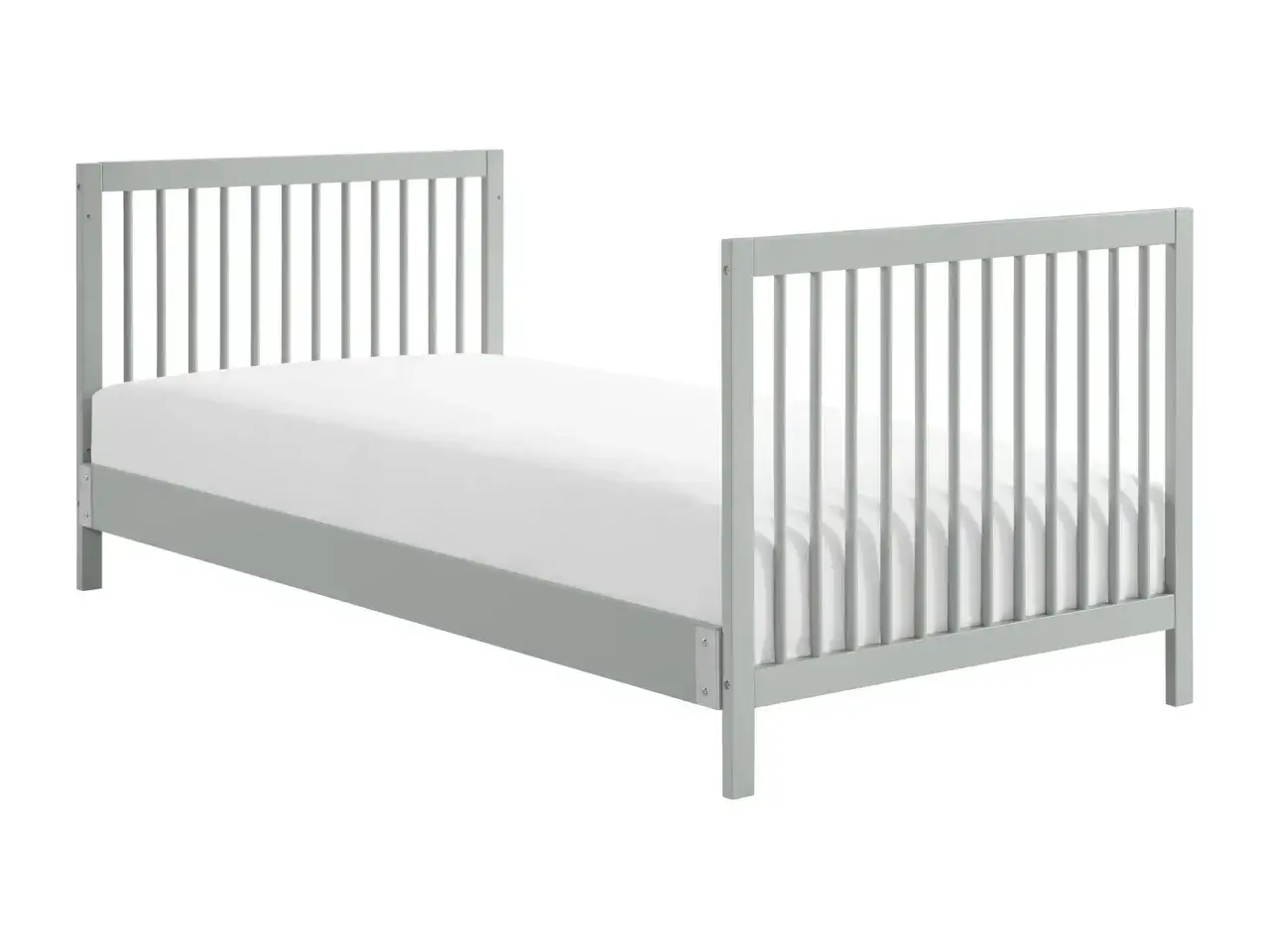 A grey toddler bed with a white mattress. This bed is designed to convert from a crib, offering a transition to twin or full sizes.