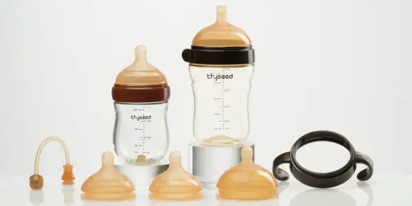 Two baby bottles and accessories. Consider how often to replace plastic baby bottles for safety.