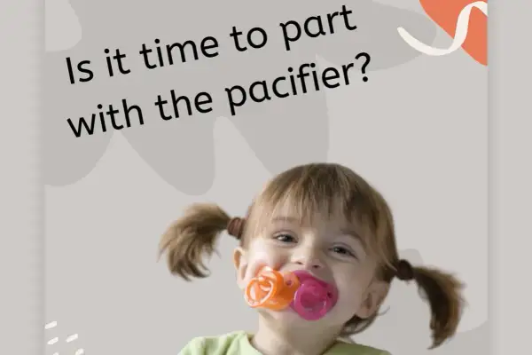 A happy toddler with pigtails is chewing on three pacifiers at once. Is it time to part with the pacifier?