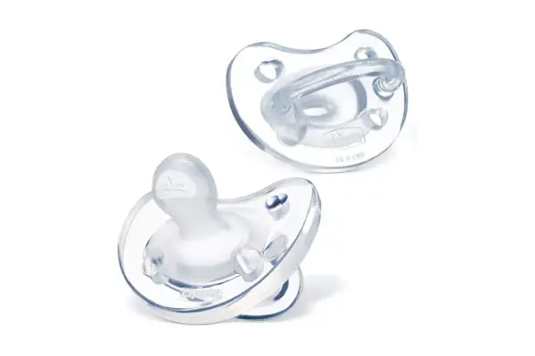 Two silicone pacifiers: one orthodontic, the other round.