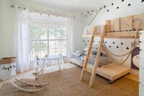 Charming toddler bedroom ideas: a wooden bunk bed, a play table, and a rocking horse create a whimsical space.