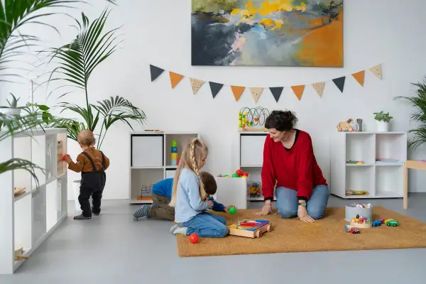 Children engage in independent play, exploring toys and learning materials, embodying the Montessori approach to play.