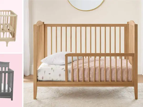 A wooden toddler bed with rails is shown, perfect for what kind of bed should a 2 year old be in. A grey crib is also visible.