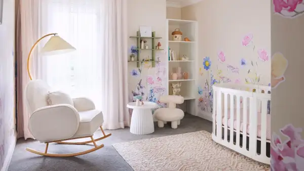 Dreamy white nursery ideas with floral wall decals, a cozy rocking chair, and a sweet crib.